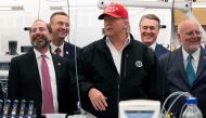 US President Donald Trump (C) gestures during a tour of the Centers for Disease Control and Prevention (CDC) as US Representative Doug Collins (2L) and US Health and Human Services Secretary Alex Azar (L) look on in Atlanta, Georgia, on March 6, 2020./ AF