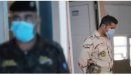 A member of Iranian Border Guards wears a protective face mask, following an outbreak of the new coronavirus, inside the Shalamcha Border Crossing, after Iraq shut a border crossing to travellers between Iraq and Iran, Iraq March 8, 2020. REUTERS/Essam al