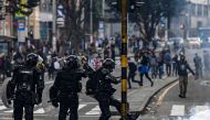 A riot policeman kicks a tear gas canister during a protest against the government of Colombia's President Ivan Duque, in Bogota, on November 23, 2019. AFP / Juan Barreto