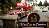 An ambulance arrives at the Life Care Center of Kirkland, the Seattle-area nursing home at the epicenter of one of the biggest coronavirus outbreaks in the United States, in Kirkland, Washington, U.S. March 10, 2020. REUTERS/Jason Redmond
 