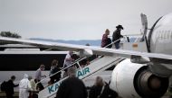 Passengers from the Princess Cruises Grand Princess cruise ship board a charter plane at Oakland International Airport on March 10, 2020 in Oakland, California.  Justin Sullivan / AFP