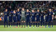 Real Madrid's players observe a minute of silence for former Betis player Manuel Regatero before the Spanish league football match between Real Betis and Real Madrid CF at the Benito Villamarin stadium in Seville on March 8, 2020. / AFP / CRISTINA QUICLER