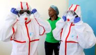  FILE PHOTO: Kenyan nurses wear protective gear during a demonstration of preparations for any potential coronavirus cases at the Mbagathi Hospital, isolation centre for the disease, in Nairobi, Kenya March 6, 2020. REUTERS/Njeri Mwangi/File Photo 