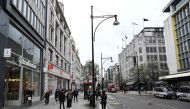 Shoppers walk on a quiet Oxford Street, central London on March 14, 2020. AFP / Glyn KIRK
