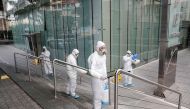 Employees of a private company spray sanitising liquid around a bank in a bid to limit the spread of the cornonavirus Civid-19, in the Lebanese capital Beirut on March 15, 2020. / AFP / ANWAR AMRO
