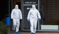 Medical staff in protective gear walk at the infectious ward of the Multidisciplinary City Hospital of Jozef Strus in Poznan, Poland March 12, 2020. Lukasz Cynalewski/Agencja Gazeta/via REUTERS
