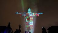 The statue of Christ the Redeemer is lit up in the colors of the countries that are affected by the coronavirus disease (COVID-19) outbreak in Rio de Janeiro, Brazil, March 18, 2020. REUTERS/Sergio Moraes