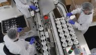 This handout picture taken on March 16, 2020 and released by French luxury group LVMH on March 17, 2020 shows workers at the Christian Dior cosmetics and perfume factory in Jean-de-Braye making hand sanitizers to be given for free for Paris' hospitals (AP