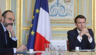 French President Emmanuel Macron (R) and French Prime Minister Edouard Philippe takes part on a videoconference of the 