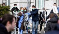 Medical staff and volunteers evacuate a maternity hospital in Zagreb, on March 22, 2020, after an earthquake hit the country at 06:00 am (0500 GMT).  AFP / Denis Lovrovic
 