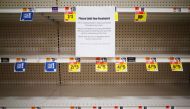 A message is posted on near empty shelves for canned goods in a supermarket in Washington, DC on March 20, 2020.  / AFP / MANDEL NGAN
