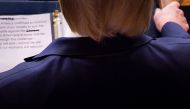 S President Donald Trump looks at his notes showing the word 