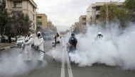 FILE PHOTO: Members of firefighters wear protective face masks, amid fear of coronavirus disease (COVID-19), as they disinfect the streets, ahead of the Iranian New Year Nowruz, March 20, in Tehran, Iran March 18, 2020. Picture taken March 18, 2020. WANA 