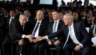 Head of Israel's Blue and White Party Benny Gantz and Israeli Prime Minister Benjamin Netanyahu shake hands as they attend a memorial ceremony for the late prime minister Yitzhak Rabin at Mount Herzl military cemetery in Jerusalem as Israel marks the 24th