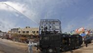 Iraqis use an anti-riot water-cannon vehicle to spray disinfecting liquid in the streets of the centre of the southern city of Basra on March 25, 2020, in a bid to slow down the spread of the novel coronavirus that causes the COVID-19 disease. / AFP / Hus