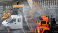 A municipal vehicle disinfects a street on the outskirts of Moscow on March 28, 2020, as the city attempts to curb the spread of the COVID-19, the disease caused by the novel coronavirus. / AFP / Kirill KUDRYAVTSEV