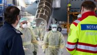 A Bundeswehr handout photo shows staff in protective suits leaving the German air force Airbus A-310 