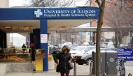 A woman walks outside the University of Illinois Hospital. REUTERS/Joshua Lott