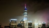 The One World Trade Center is illuminated in red, white and blue in recognition of the ongoing nationwide effort to combat coronavirus during the outbreak of the coronavirus disease (COVID-19) in New York City, as it is seen from Exchange Place, New Jerse