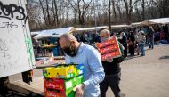 Saturday shoppers wearing protection masks carry their goods at the Yorck Strasse market in Berlin on March 28, 2020 amid the novel coronavirus pandemic. . / AFP / Odd ANDERSEN