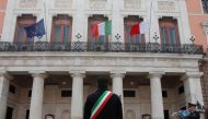 Mayor of Bari Antonio Decaro attends a ceremony to draw an Italian flag to half mast as mayors across Italy stand in silence to honour the country's dead due to coronavirus disease (COVID-19), in Bari, Italy, March 31, 2020. REUTERS/Alessandro Garofalo