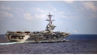 In this file US Navy handout photo obtained March 31, 2020 shows an F/A-18F Super Hornet, assigned to the “Black Knights” of Strike Fighter Squadron (VFA) 154, launching from the flight deck of the aircraft carrier USS Theodore Roosevelt (CVN 71), on Marc