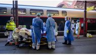 Medical staff carry a patient infected with the COVID-19 onboard a medicalized TGV high speed train at the railway station in Strasbourg, France, April 3, 2020. Patrick Hertzog/Pool via Reuters
