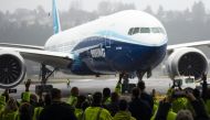 In this file photo taken on January 25, 2020, Boeing employees and guests welcome a Boeing 777X airplane returning from its inaugural flight at Boeing Field in Seattle, Washington. / AFP / Jason Redmond