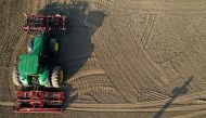 FILE PHOTO: A French farmer drives his tractor to prepare the land before sugar beets sowing in Anneux, France, March 27, 2020. Picture taken with a drone. REUTERS/Pascal Rossignol/File Photo