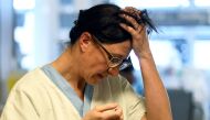 A medical staff member reacts in the intensive care unit, where patients suffering from the coronavirus disease (COVID-19) are treated, at the Circolo hospital in Varese, Italy April 9, 2020. REUTERS/Flavio Lo Scalzo