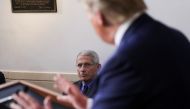 National Institute of Allergy and Infectious Diseases director Dr. Anthony Fauci listens to U.S. President Donald Trump speak during the daily coronavirus task force briefing at the White House in Washington, US, April 13, 2020. REUTERS/Leah Millis