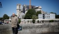 French Army General Jean-Louis Georgelin, in charge of Notre-Dame Cathedral reconstruction, stays at distance to answer journalists questions in Paris, France, April 14, 2020. REUTERS/Benoit Tessier