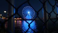 Seattle, WA - APRIL 9: A general view of The Seattle Great Wheel lit up in blue to honor essential workers during the coronavirus (COVID-19) outbreak on April 09, 2020 in Seattle, Washington.  Abbie Parr/AFP
