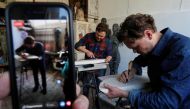 Ukrainian contemporary artists, brothers Nikita and Egor Zigura work in their workroom during an online auction in Kiev, Ukraine, April 13, 2020. Picture taken April 13, 2020. REUTERS/Gleb Garanich