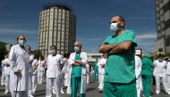 Staff from La Paz hospital take a minute of silence to remember Joaquin Diaz, the hospital's chief of surgery who died of COVID-19, amid the coronavirus disease (COVID-19) outbreak in Madrid, Spain, April 20, 2020. REUTERS/Susana Vera