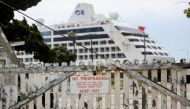 :SAN PEDRO, CALIFORNIA - APRIL 20: The Pacific Princess cruise ship is shown docked at the Port of Los Angeles after arriving earlier in the day on April 20, 2020 in San Pedro, California. The ship was one of the last three remaining cruise ships still sa