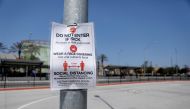 A coronavirus warning sign is posted at a closed pedestrian crossing at the U.S.-Mexico border during the coronavirus disease (COVID-19) outbreak in San Diego, California, U.S., April 21, 2020. REUTERS/Mike Blake
