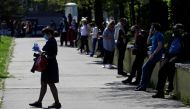 People keep social distance while waiting in line to be tested for the coronavirus disease (COVID-19) as a part of a study about undetected infections with the coronavirus in the population in Prague, Czech Republic, April 23, 2020. REUTERS/David W Cerny