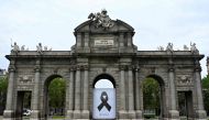 A black ribbon commemorating coronavirus victims hangs on the Puerta de Alcala in Madrid on April 23, 2020 amid a national lockdown to fight the spread of the COVID-19 coronavirus. Spain said 440 people died in the past 24 hours from the new coronavirus, 