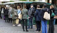 People stand in a queue at a farmers market at Boxhagener Platz, as the spread of the coronavirus disease (COVID-19) continues, in Berlin, Germany April 25, 2020. REUTERS/Christian Mang