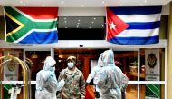 This hand out photo taken and released by GCIS on April 27, 2020, shows Cuban Health Specialists arriving at the Waterkloof Air Force Base in Pretoria, South Africa, to support efforts to curb the spread of the COVID-19 coronavirus. 