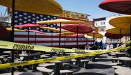 NEW YORK, NY - APRIL 25: Despite caution tape blocking off a seating section due to the coronavirus, people still sit down to enjoy a spring afternoon at Brooklyn's Coney Island on April 25, 2020 in New York City. Spencer Platt/AFP 
