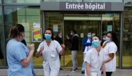 Medical Staff dance in front of the Pasteur university hospital (CHU) at 8 o'clock, as part of a daily tribute to health workers, in the French Riviera city of Nice, southern France, on April 27, 2020, on the 42nd day of a lockdown in France aimed at curb