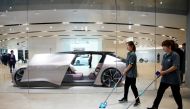 FILE PHOTO: Cleaners are seen next to a self-driving electric concept car NIO Eve displayed at the second media day for the Shanghai auto show in Shanghai, China April 17, 2019. REUTERS/Aly Song