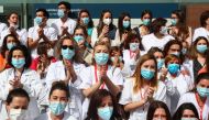 Health workers wearing protective face masks react after last patients were discharged from a temporary hospital set up at IFEMA fairgrounds, before it's closure, amid the coronavirus disease (COVID-19) outbreak in Madrid, Spain May 1, 2020. REUTERS/Sergi