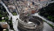 This aerial photograph taken on May 1, 2020 shows the empty streets and the Colosseum in Rome during the country's lockdown aimed at curbing the spread of the COVID-19. / AFP / Filippo MONTEFORTE
