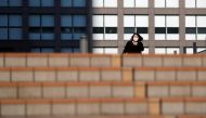 A woman wearing a protective face mask walks on a street during a Golden Week, a week-long holiday in Japan, under a nationwide state of emergency in Tokyo, Japan May 1, 2020, as the spread of the coronavirus disease (COVID-19) continues. REUTERS/Issei Ka