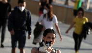 A woman walks as she holds a cat during the hours in which individual exercise is allowed outdoors, for the first time since the lockdown was announced, amid the coronavirus disease (COVID-19) outbreak, in Barcelona, Spain, May 2, 2020. REUTERS/Nacho Doce