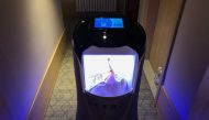 This photo taken on April 28, 2020 shows a robot capable of taking elevators and navigating hallways on its own delivering food to a guest at a quarantine hotel housing people from Hubei province in Beijing. AFP / Jing Xuan Teng