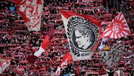FILE PHOTO: Cologne's supporters wave their flags during the German first division Bundesliga football match 1 FC Cologne v FC Bayern Munich in Cologne, western Germany. / AFP / INA FASSBENDER
